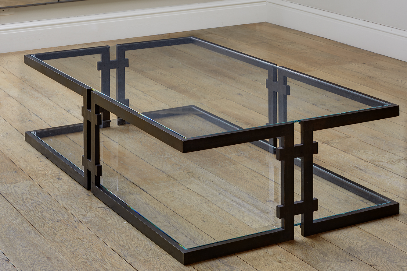 Bronzed steel framed cantilevered coffee table.